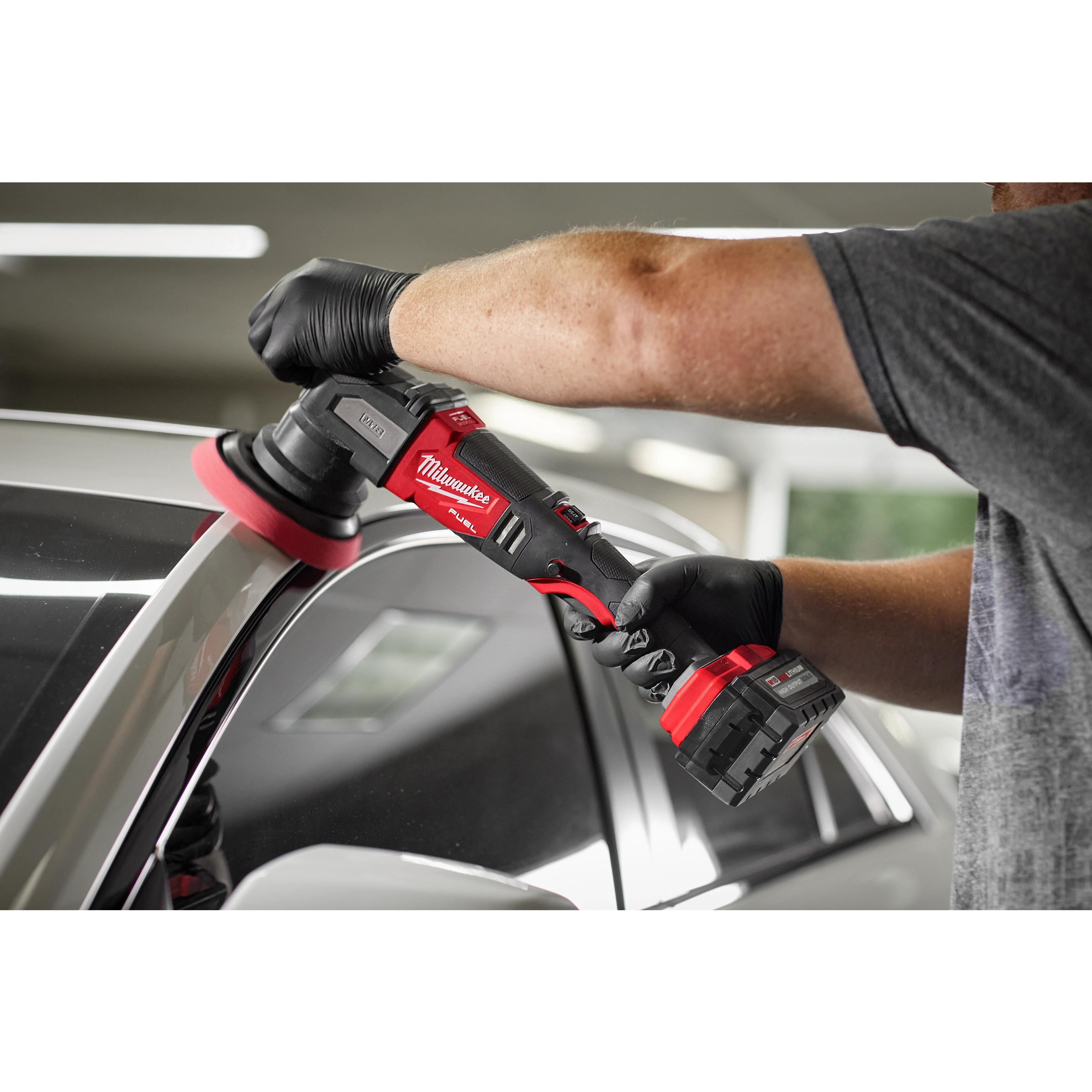 Man using the M18 FUEL 15 mm Random Orbital Polisher on a car