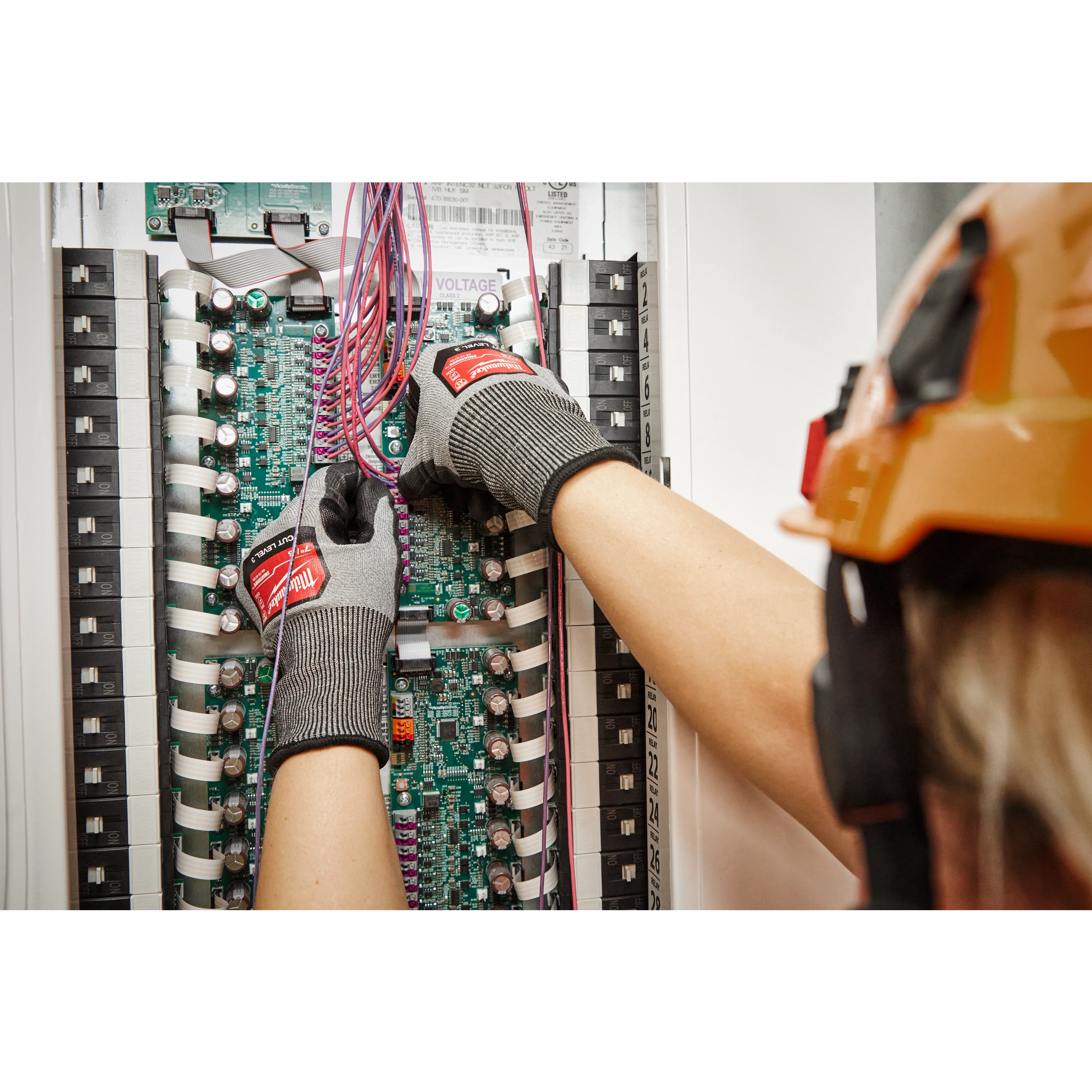 Worker wearing the Cut 3 High-Dexterity Gloves while installing cables
