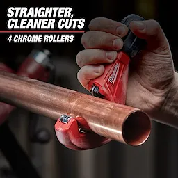 A hand is using a Milwaukee pipe cutter to cut a copper pipe. The image text reads, "Straighter, cleaner cuts, 4 chrome rollers."