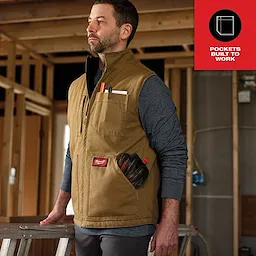Heavy Duty Sherpa-Lined Vest Feature Shot in a construction setting, worn over a grey long-sleeve shirt, with tools in the pockets.