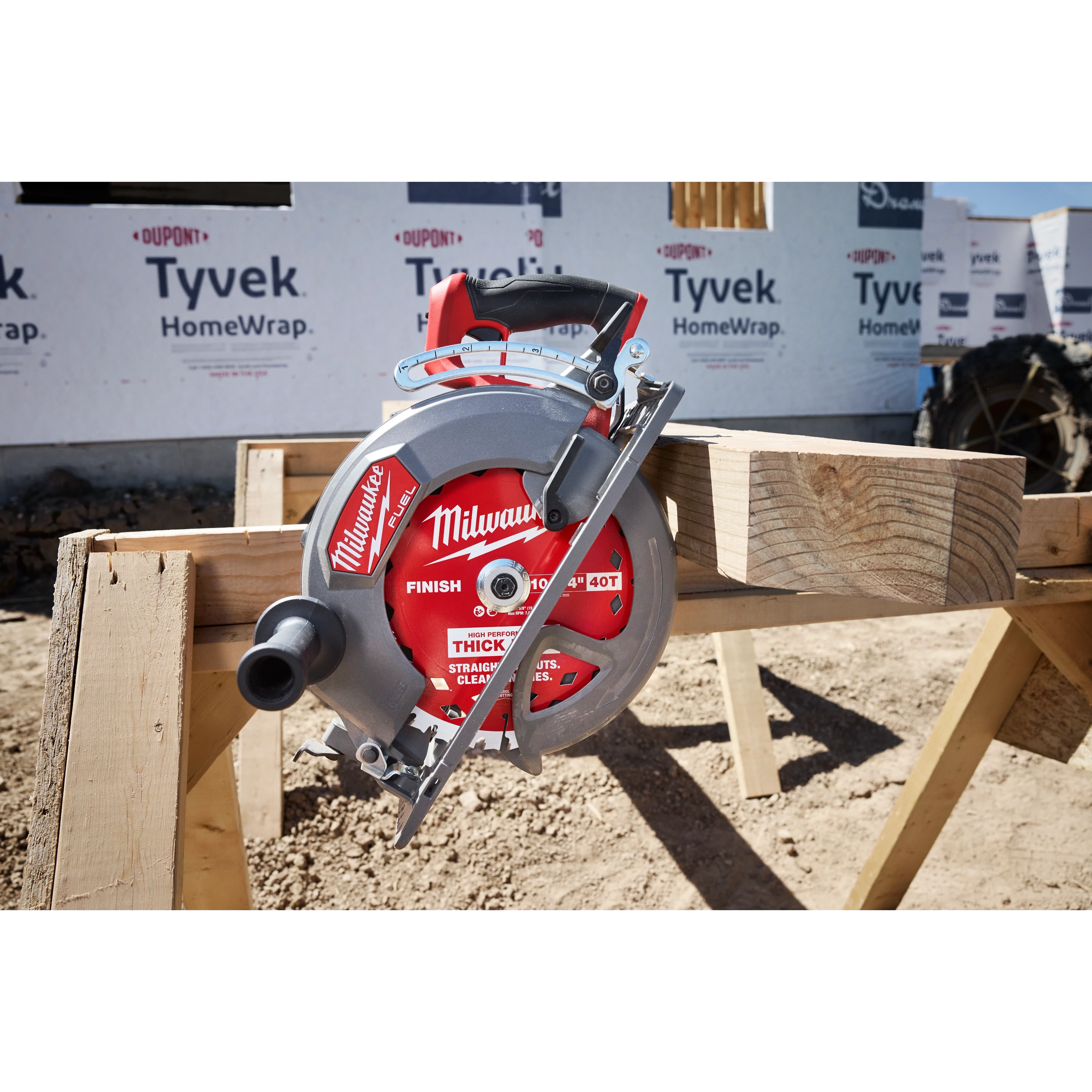 Circular saw featuring a 10-1/4" 40T Thick Kerf Finish Circular Saw Blade resting on wooden beams at a build site.