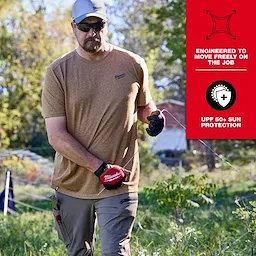 Man wearing a FREEFLEX Hybrid Work Tee - Short Sleeve in a tan color while working outdoors, with UPF 50+ sun protection.