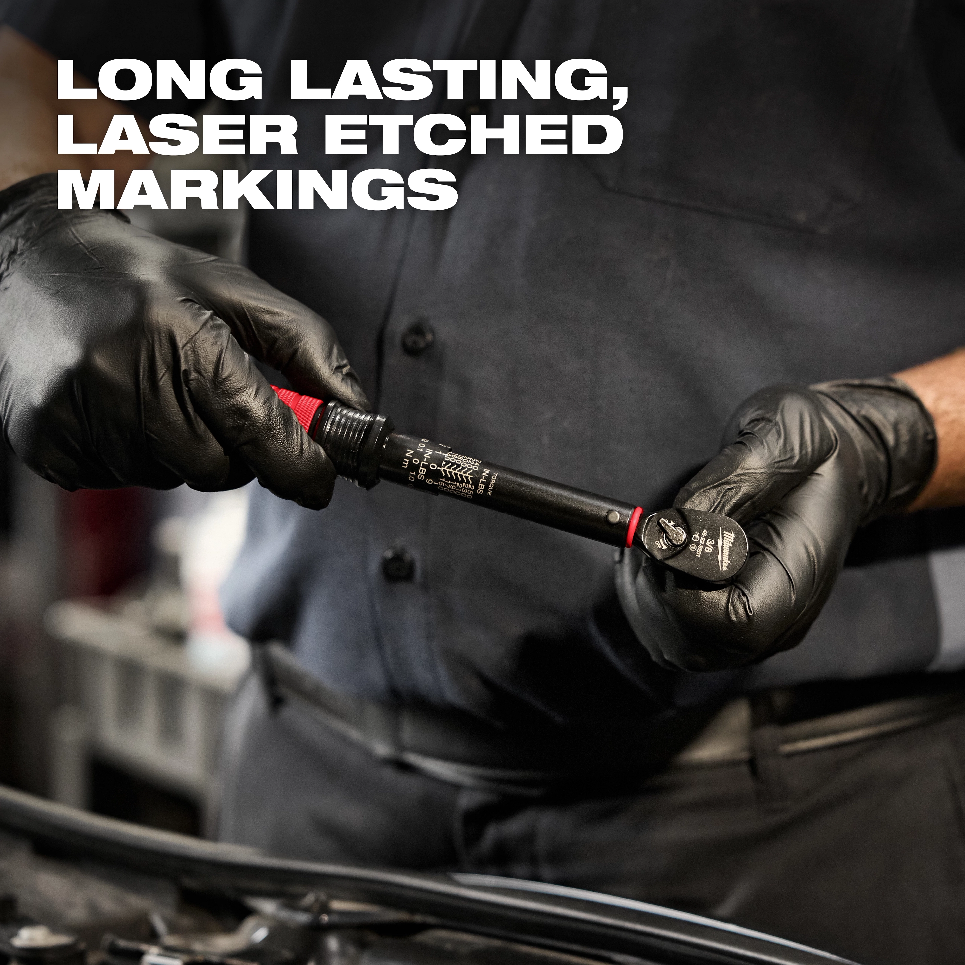 Mechanic holds 3/8" Drive Click Torque Wrench (50-250 in·lbf) with long-lasting, laser-etched markings, wearing black gloves.