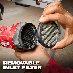 A person is removing the inlet filter from a Milwaukee M18™ Brushless Precision Blower. The words "REMOVABLE INLET FILTER" are displayed at the bottom of the image.
