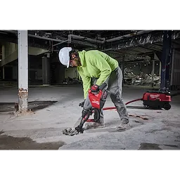 Person operating the M18 FUEL 18lb SDS MAX Demolition Hammer Kit to break concrete inside a partially demolished building.