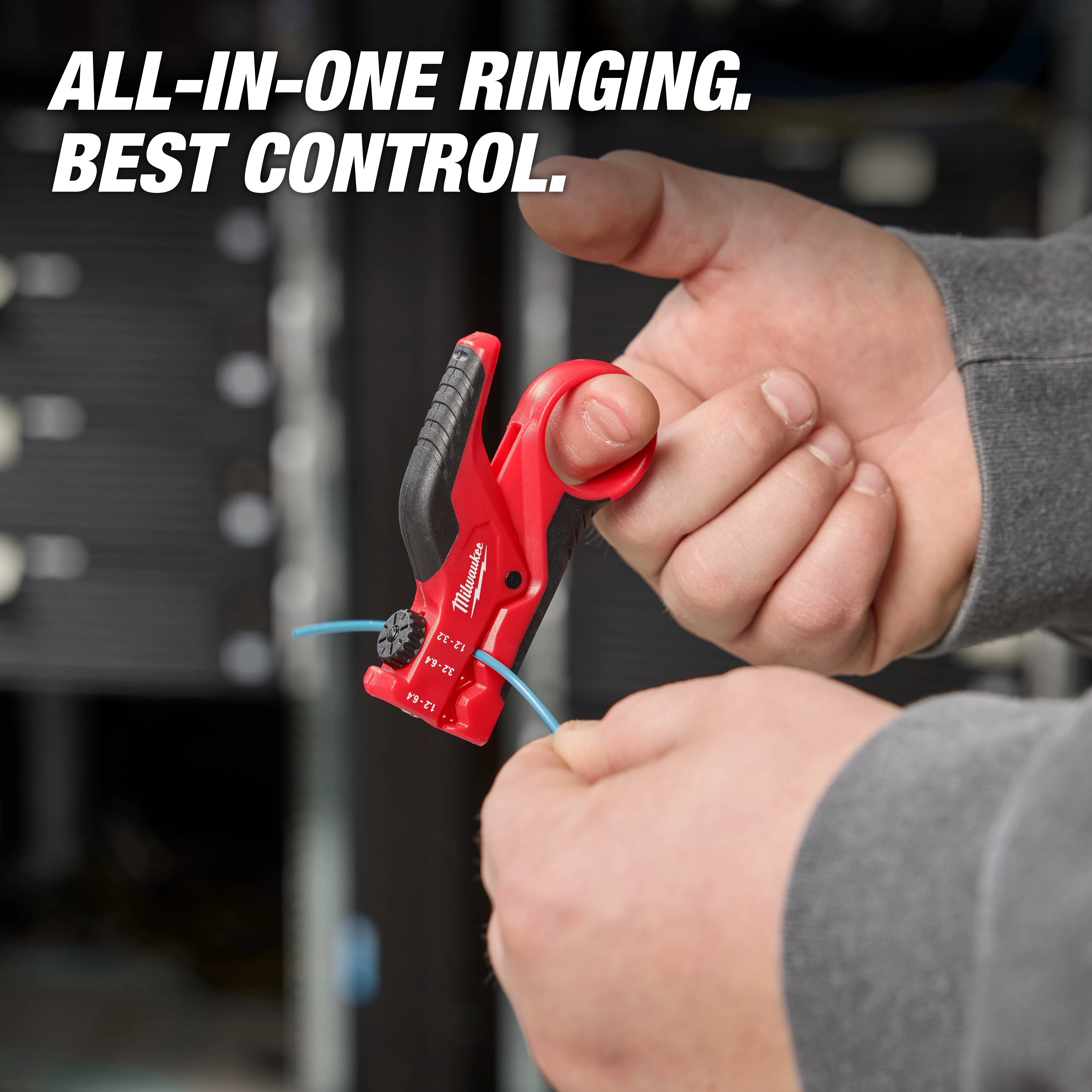 A person uses the Buffer Tube Ringer & Slitter tool to strip the outer coating from a blue wire. The red and black tool is held with one hand while the other hand guides the wire. The background is blurred. Text reads "All-In-One Ringing. Best Control."
