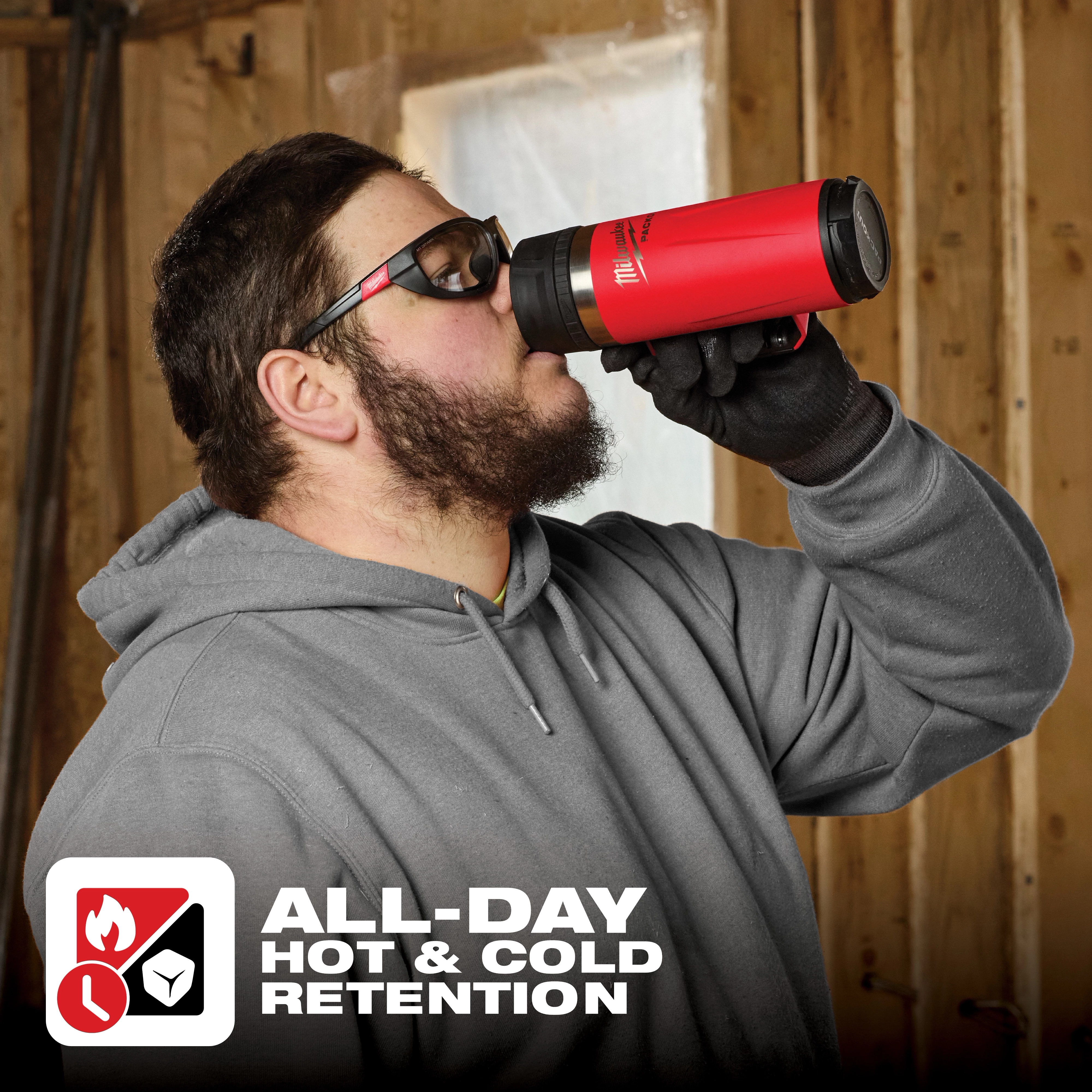 Man in work attire drinking from PACKOUT 18oz Insulated Mug with Sip Lid, designed for hot and cold retention all day.