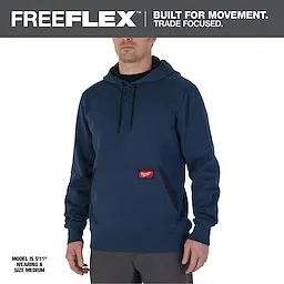 Midweight Pullover Hoodie in blue with a front pocket. Worn by a person standing, showing its fit and design. Size medium.