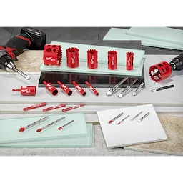 2020 Glass and Tile Accessories Family Shot features red drill bits, hole saws, and accessories arranged on tiles and glass surfaces.