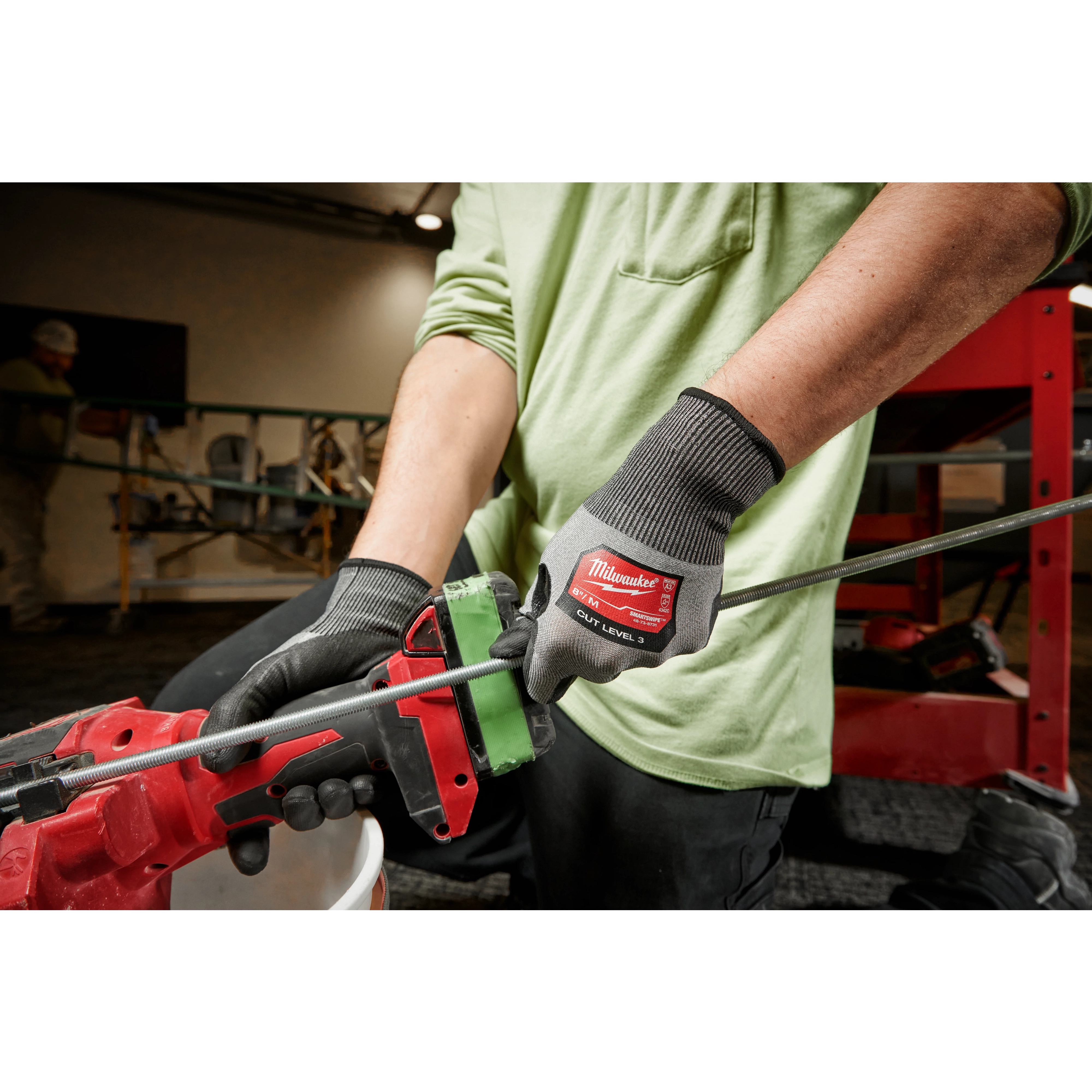 Worker wearing the Cut 3 High-Dexterity Gloves while using a power tool