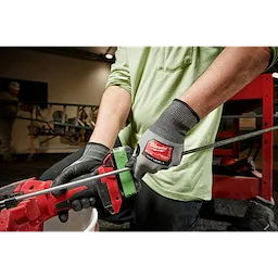 Worker wearing the Cut 3 High-Dexterity Gloves while using a power tool