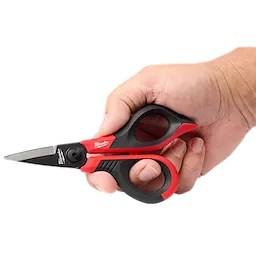 A hand holding red and black precision scissors with a short blade.