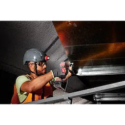 Worker wearing Cut Level 9 High-Dexterity Nitrile Dipped Gloves - L operates a power tool while installing sheet metal.