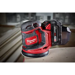 The M18 Random Orbit Sander is a red and black cordless power tool, designed for smoothing surfaces with a compact design.