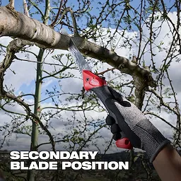 7” Folding Pruning Saw – Straight Blade cutting a tree branch, held by a gloved hand outdoors.