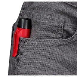 A Voltage Detector with a red body and black tip is clipped into the pocket of a pair of gray pants.