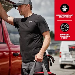 Person wearing a black FREEFLEX Hybrid Work Tee - Short Sleeve while leaning on a car, with lightweight and breathable forward shoulder design features.
