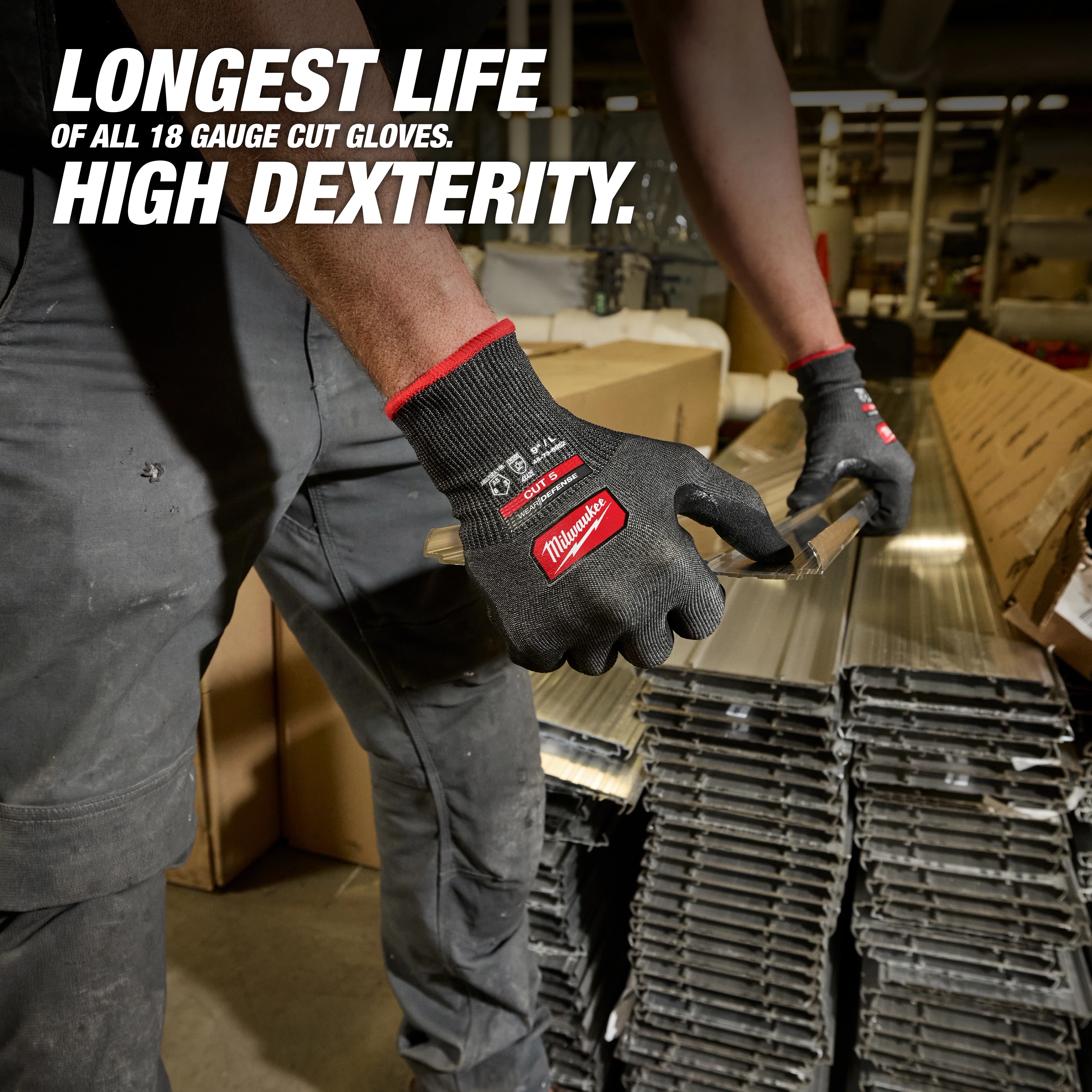 Worker wearing Cut Level 5 High Dexterity Nitrile Dipped Gloves w/ WEAR-DEFENSE Protection handling metal pieces.