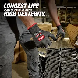 Worker wearing Cut Level 5 High Dexterity Nitrile Dipped Gloves w/ WEAR-DEFENSE Protection handling metal pieces.