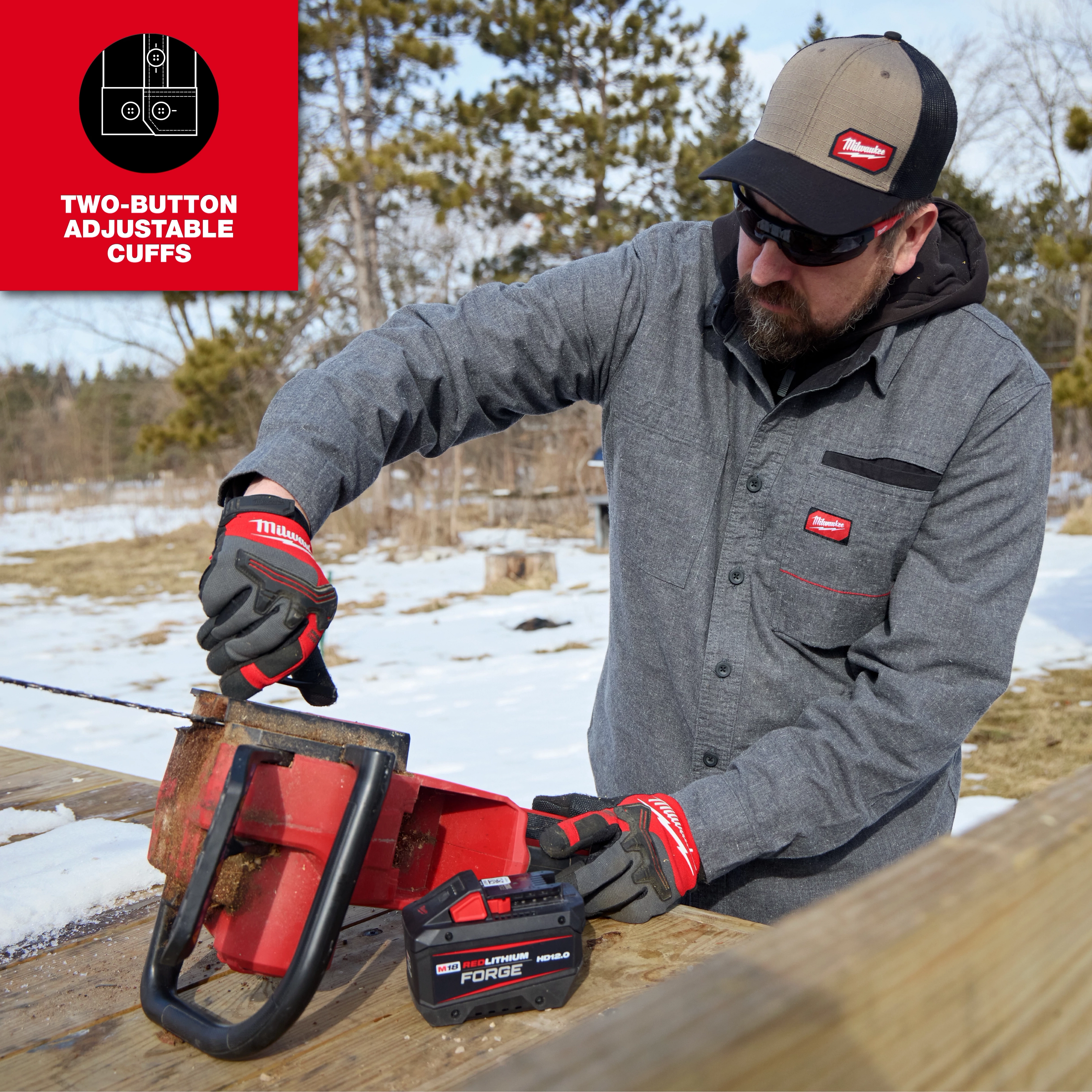 Person using a chainsaw outdoors while wearing a GRIDIRON Flannel Shirt and work gloves.