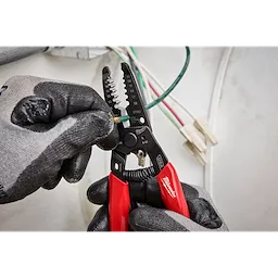 8-20 AWG Dipped Grip Wire Stripper & Cutter (USA) being used by hand in gloves, stripping a green wire.