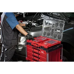 Mechanic using 67pc 1/4”, 3/8”, and 1/2” Drive TORX Bit Socket Set with PACKOUT Low-Profile Organizer beside a car.