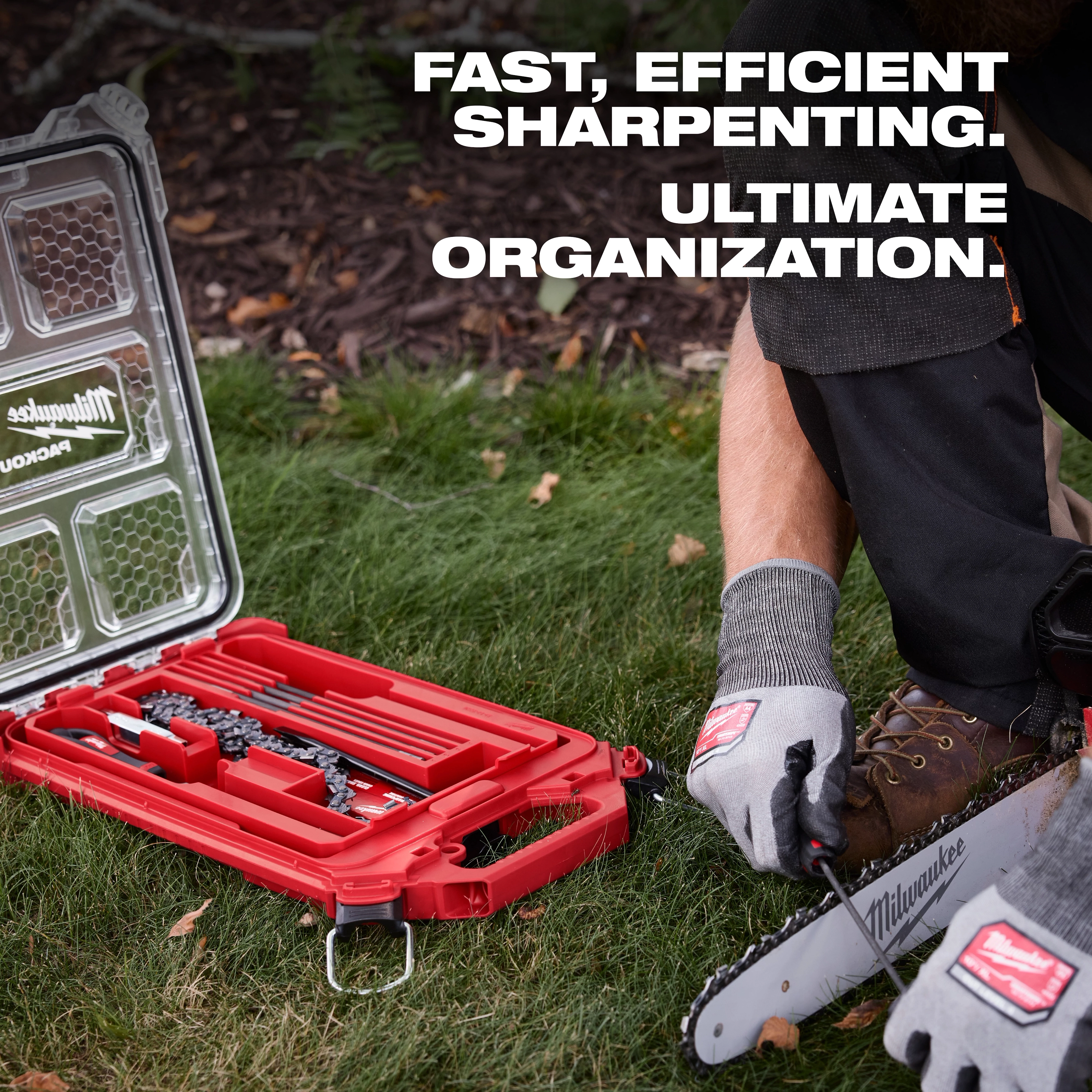 A person sharpens a saw chain using the 9pc Saw Chain Sharpening Set with PACKOUT™ Low-Profile Compact Organizer. The set includes files and tools, housed in a red, durable organizer for efficient sharpening and superior organization. The image emphasizes the ease and efficiency of use in a grassy outdoor area.
