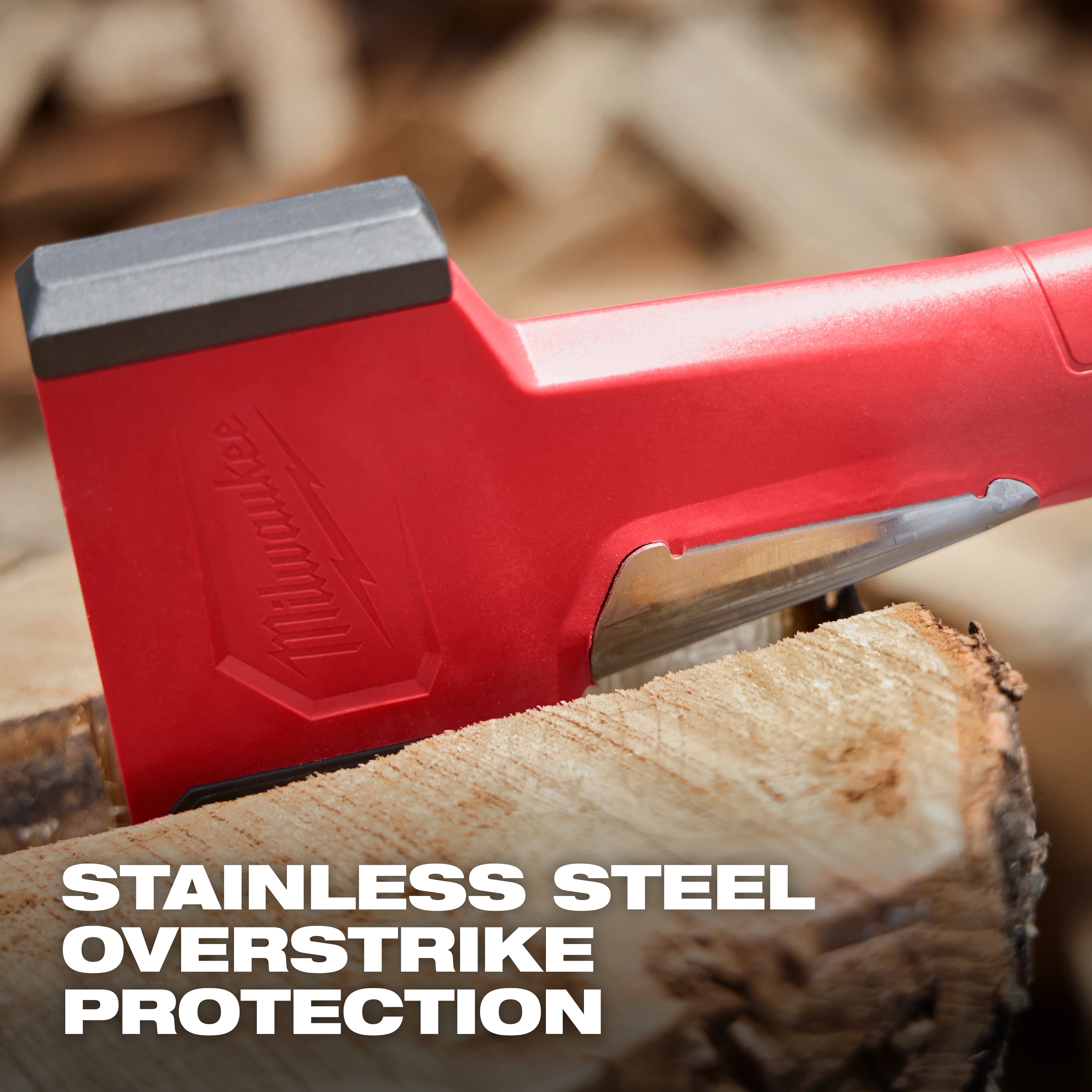 36" Splitting Axe with red handle, stainless steel blade in log. Text: "Stainless Steel Overstrike Protection."