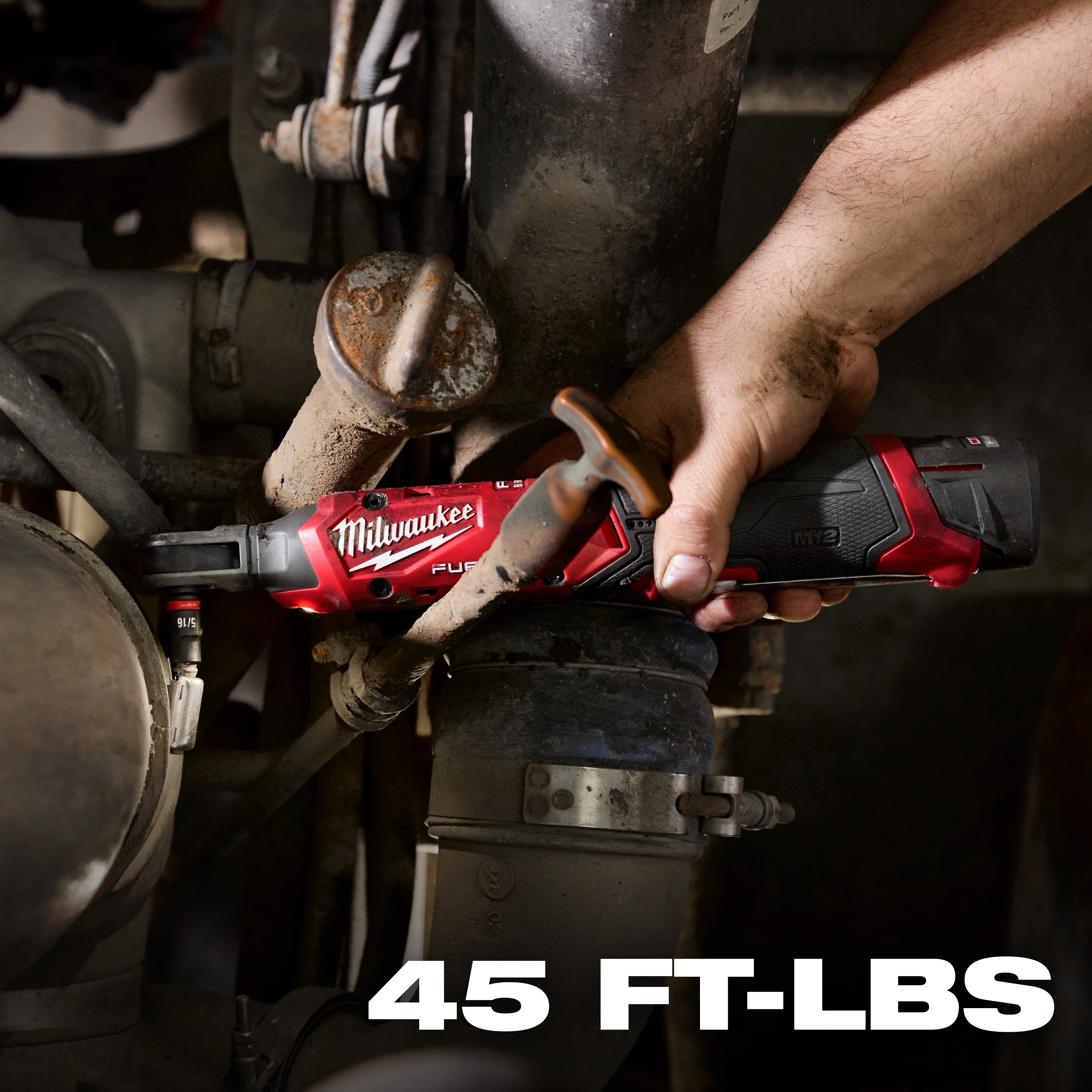 A person's hand is operating a Milwaukee M12 FUEL™ 1/4" Ratchet, applying torque to a metal pipe connection. The tool is red and black and positioned in a tight space. The image highlights the ratchet's 45 ft-lbs torque capability in white text at the bottom.