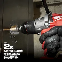 A gloved hand uses a red power drill with a Cobalt Step Bit, drilling into a stainless steel surface. Text on the image highlights "Up to 2x Faster Starts in Stainless with Rapid Strike™ Tip." The bit appears to be working efficiently, creating a smooth and clean hole.