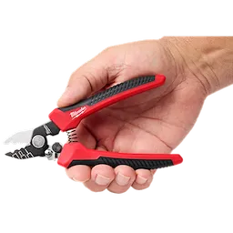 Hand holding red and black wire stripper with visible brand logo.