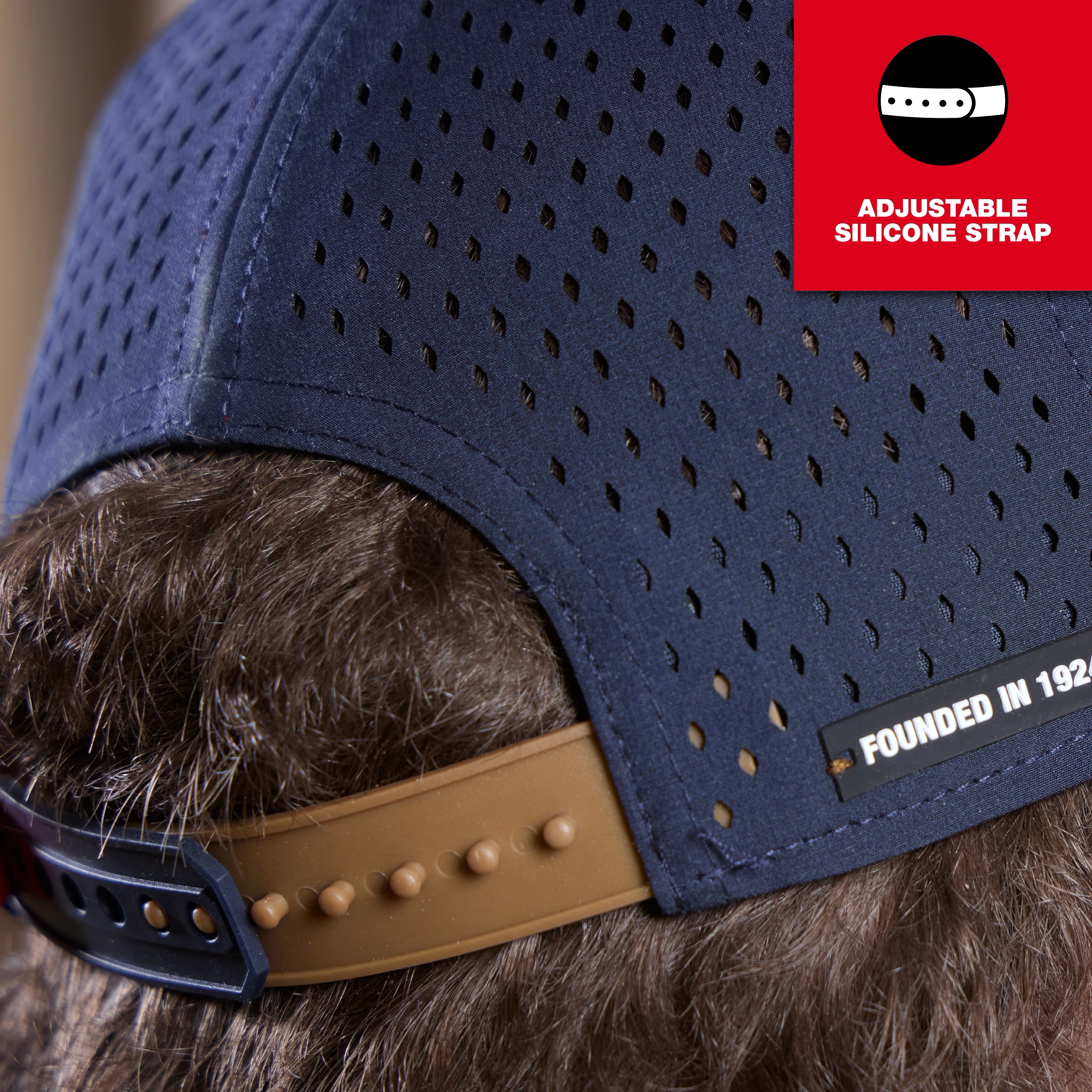 Flat Brim Snapback hat with adjustable silicone strap. Navy blue with perforations.