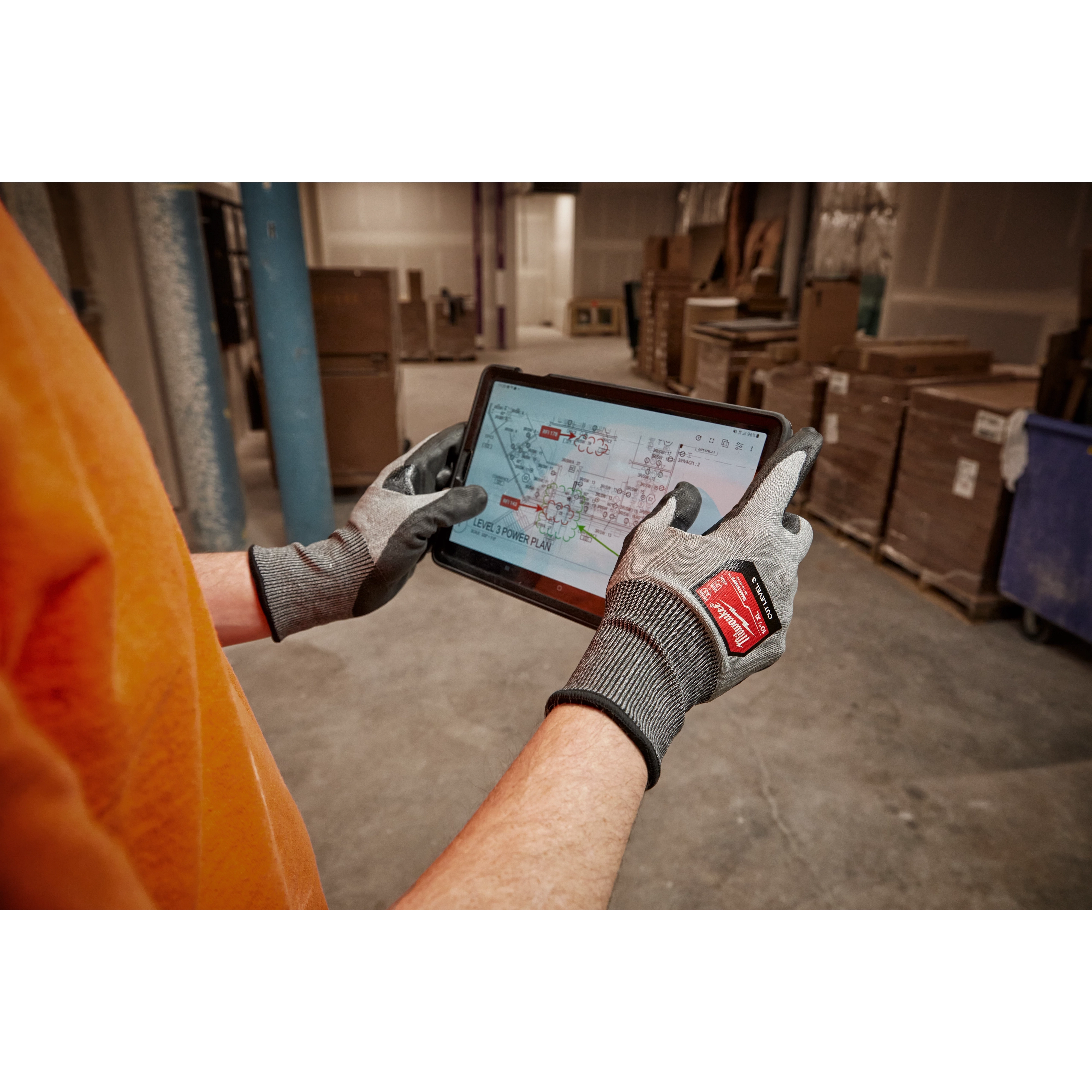 Worker wearing the Cut 3 High-Dexterity Gloves while using a tablet