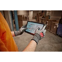 Worker wearing the Cut 3 High-Dexterity Gloves while using a tablet