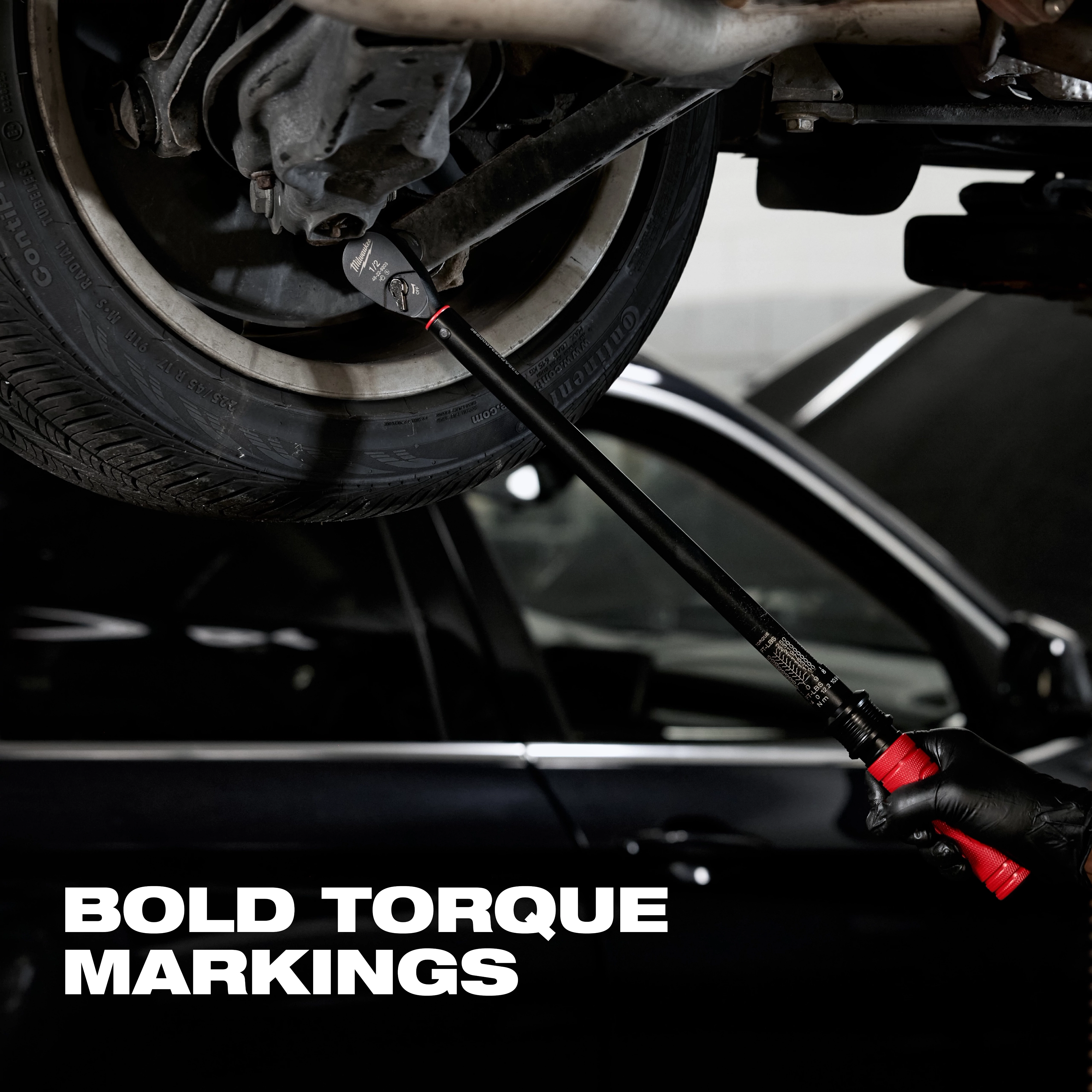 1/2" Drive Click Torque Wrench (50-250 ft·lbf) being used to tighten a lug nut on a car wheel, emphasizing bold torque markings.