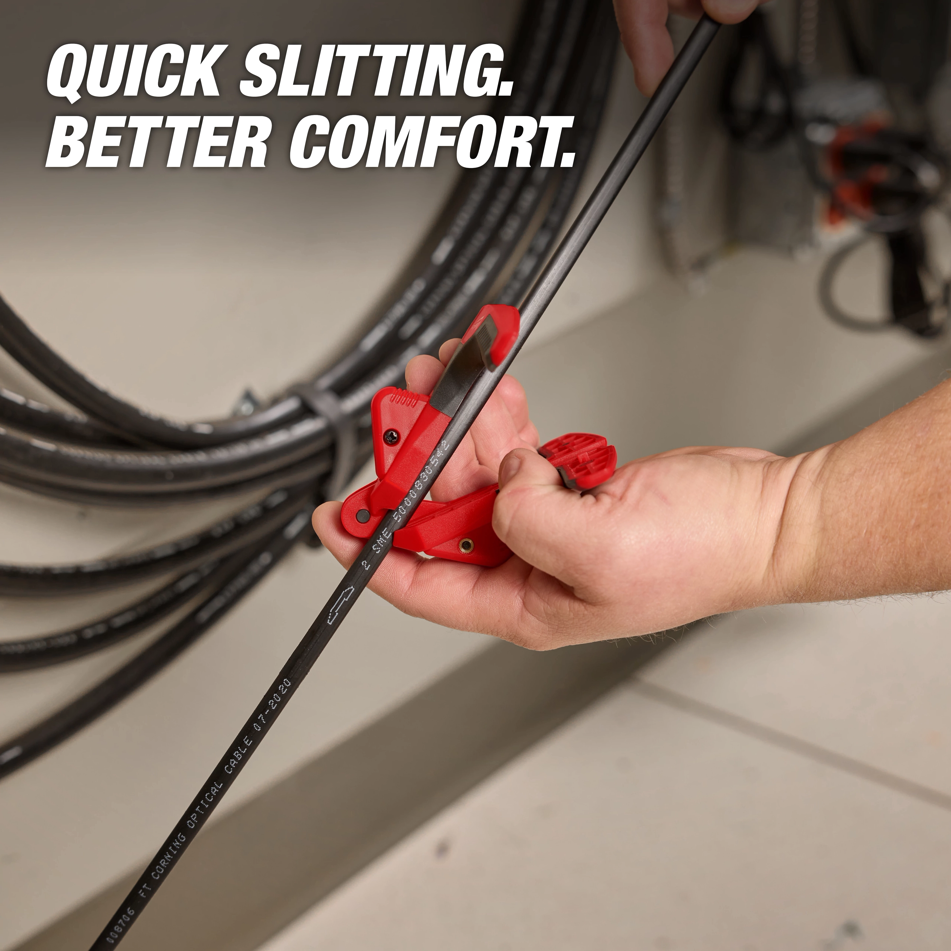 The image shows a person using a Fiber Optic Drop Cable Slitter to slit a fiber optic cable. The red tool is fitted around the cable being worked on. Text on the image reads "Quick Slitting. Better Comfort." Cables and equipment are visible in the background.
