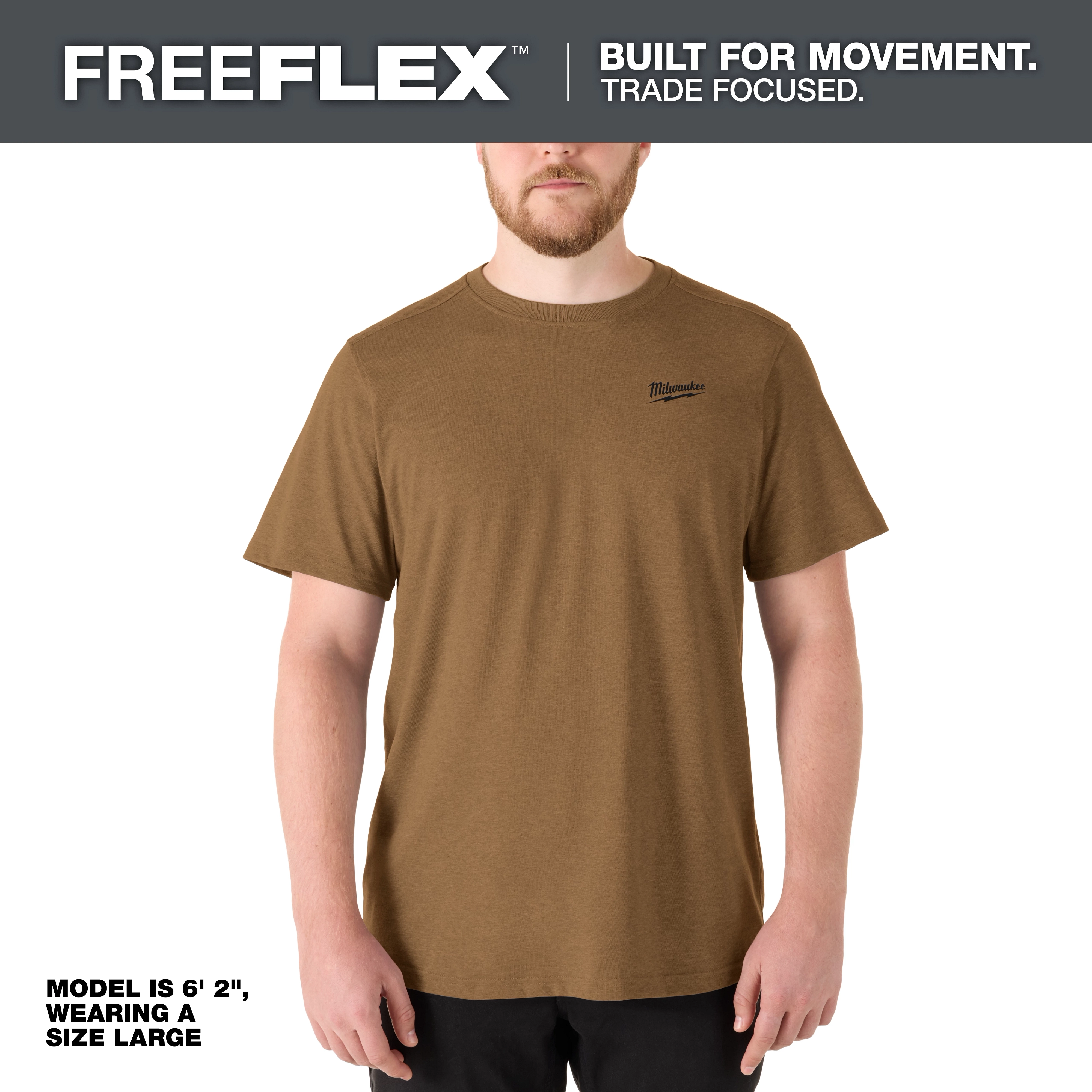 Model wearing the FREEFLEX Hybrid Work Tee - Short Sleeve in brown. Model is 6' 2" and wearing a size large.