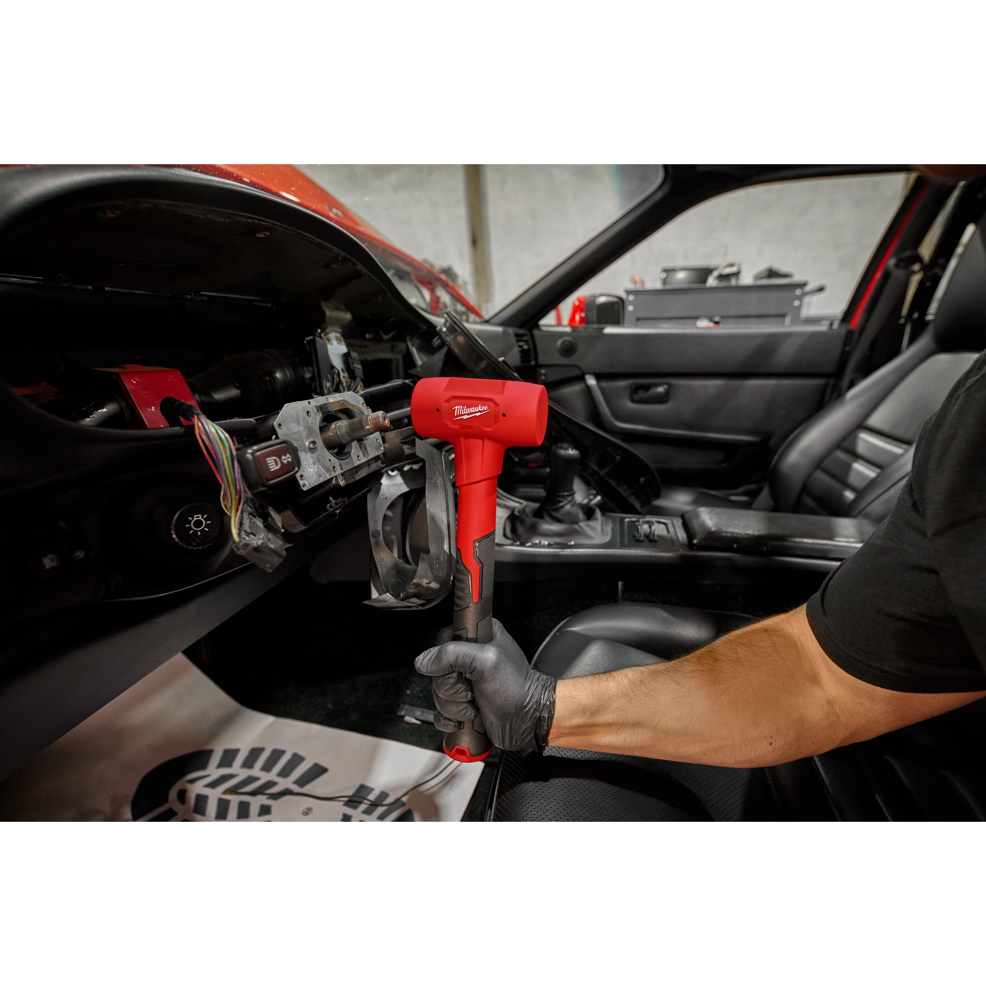 Worker using the 32oz Dead Blow Ball Peen Hammer for automotive use