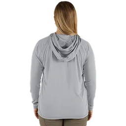 The image features the back view of a person wearing the Women's WORKSKIN Hooded Sun Shirt – Gray. The shirt includes a hood and long sleeves, designed for sun protection, and is paired with khaki pants.