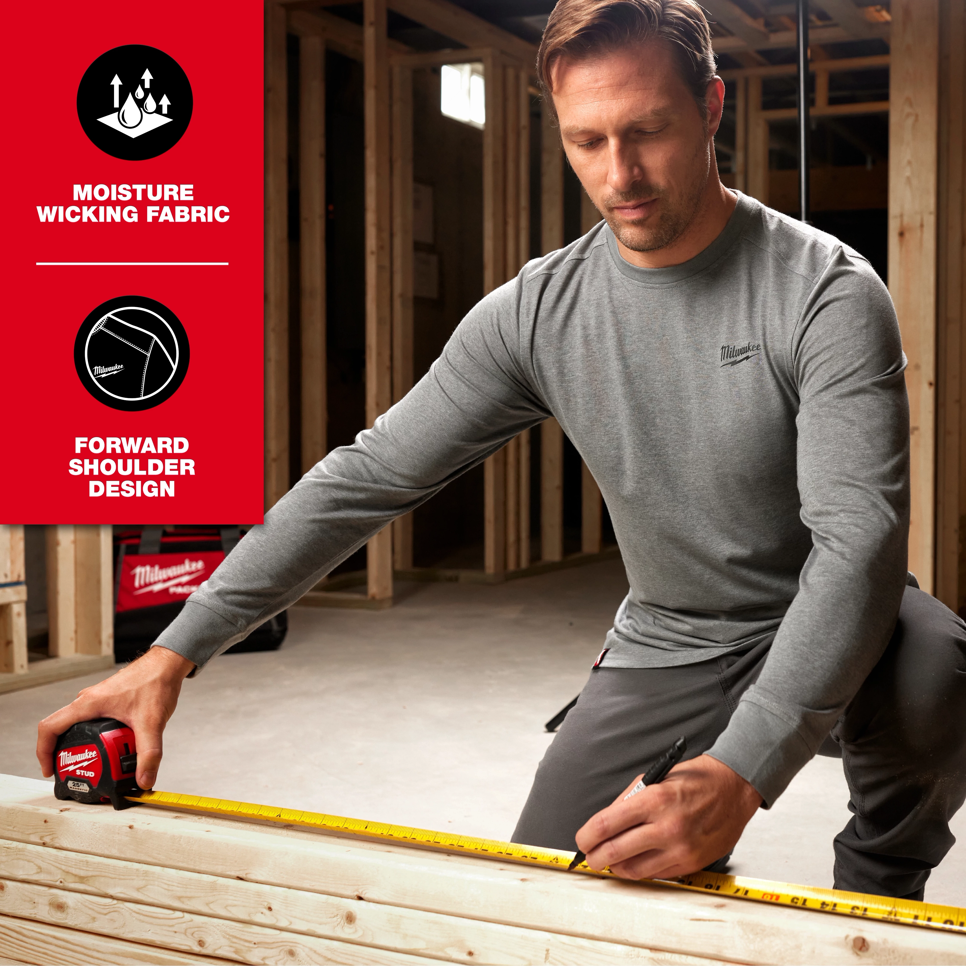 Man wearing FREEFLEX Hybrid Work Tee - Long Sleeve in a construction setting, demonstrating its moisture-wicking fabric and forward shoulder design.