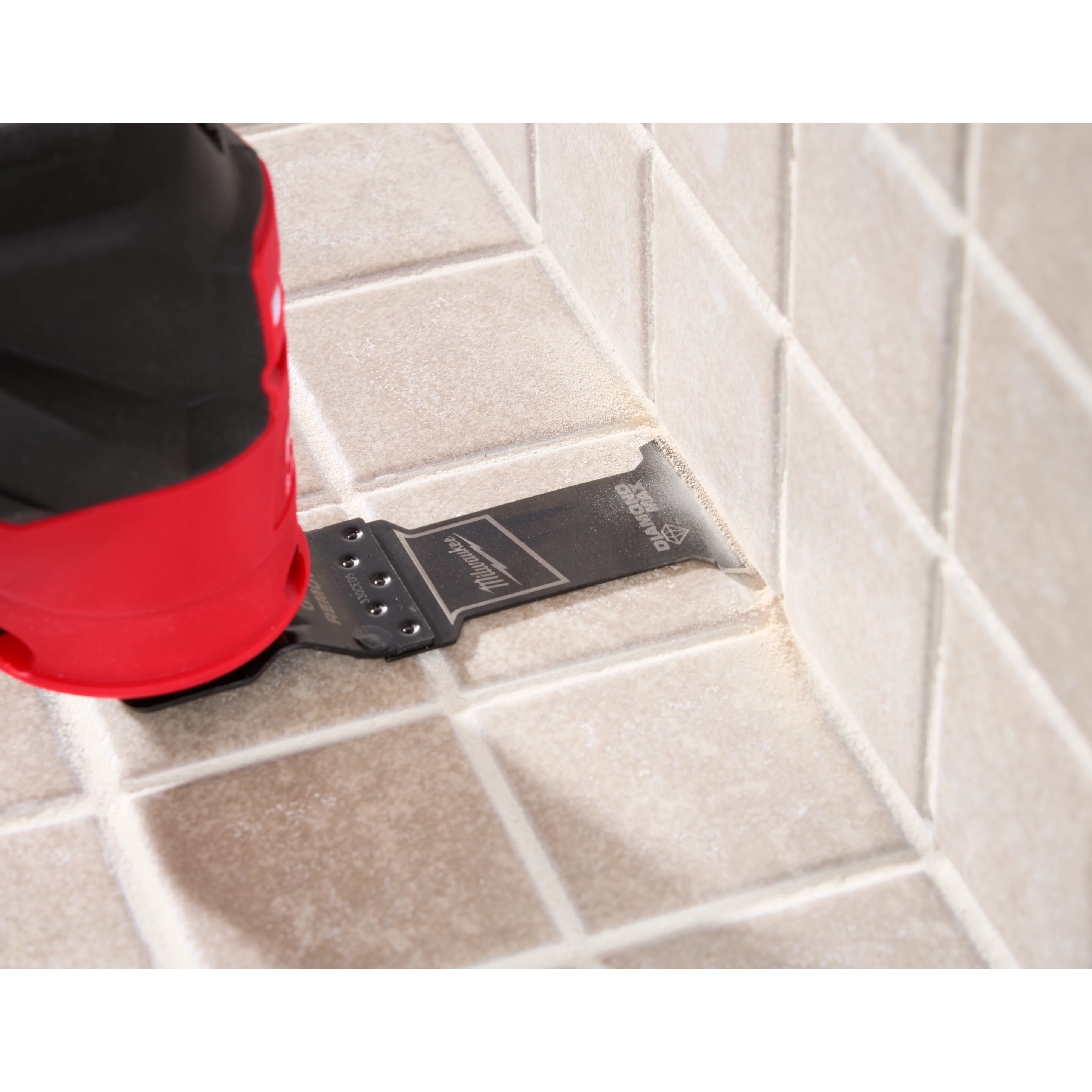 Image of the OPEN-LOK™ DIAMOND MAX™ Diamond Grit Grout Removal Multi-Tool Plunge Blade being used in a Milwaukee Multi-Tool on tile