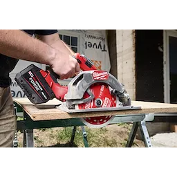 A handheld circular saw cuts a board, featuring a 7-1/4" 40T Thick Kerf Finish Circular Saw Blade.