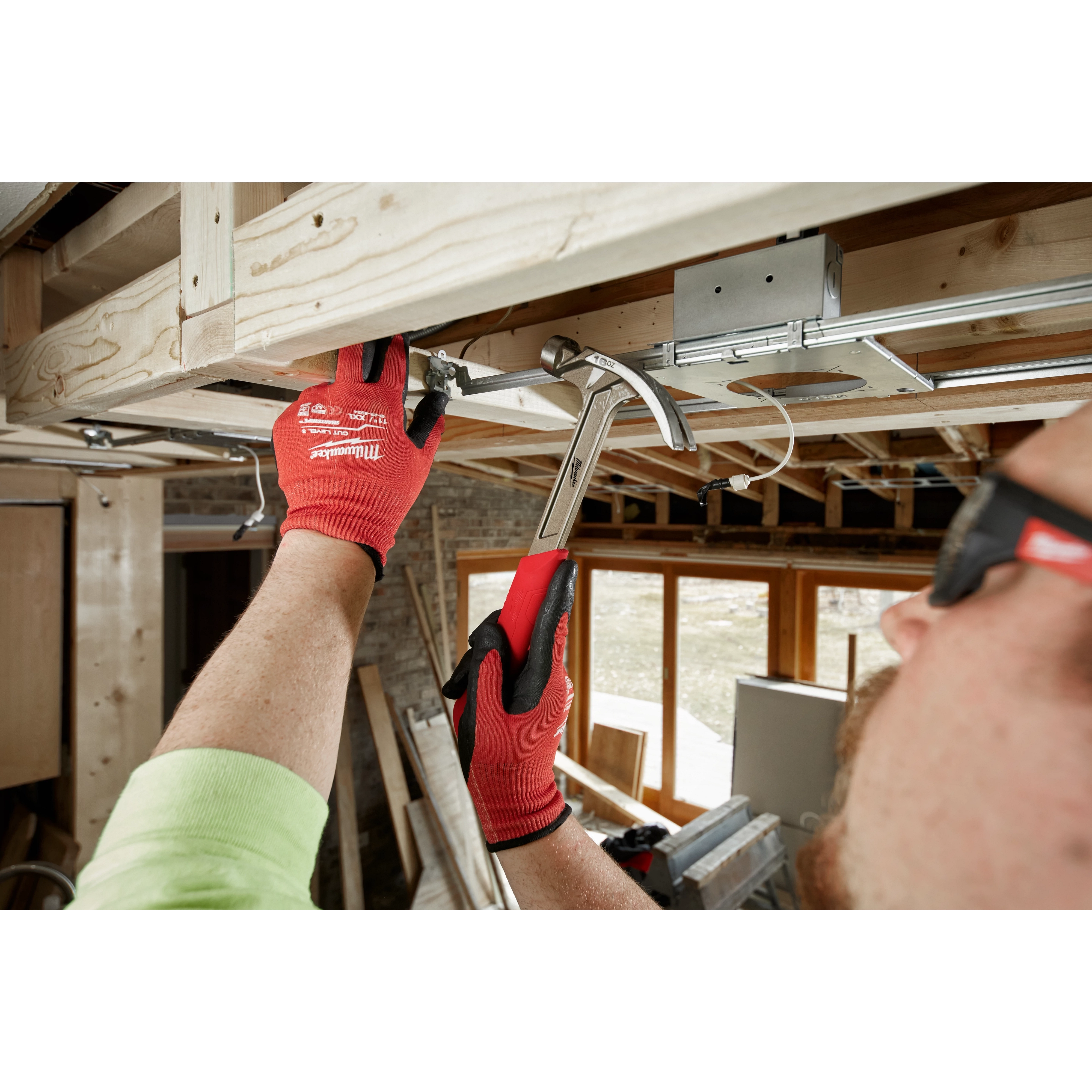 Worker using the Hammer Expansion on the jobsite to hammer in a nail