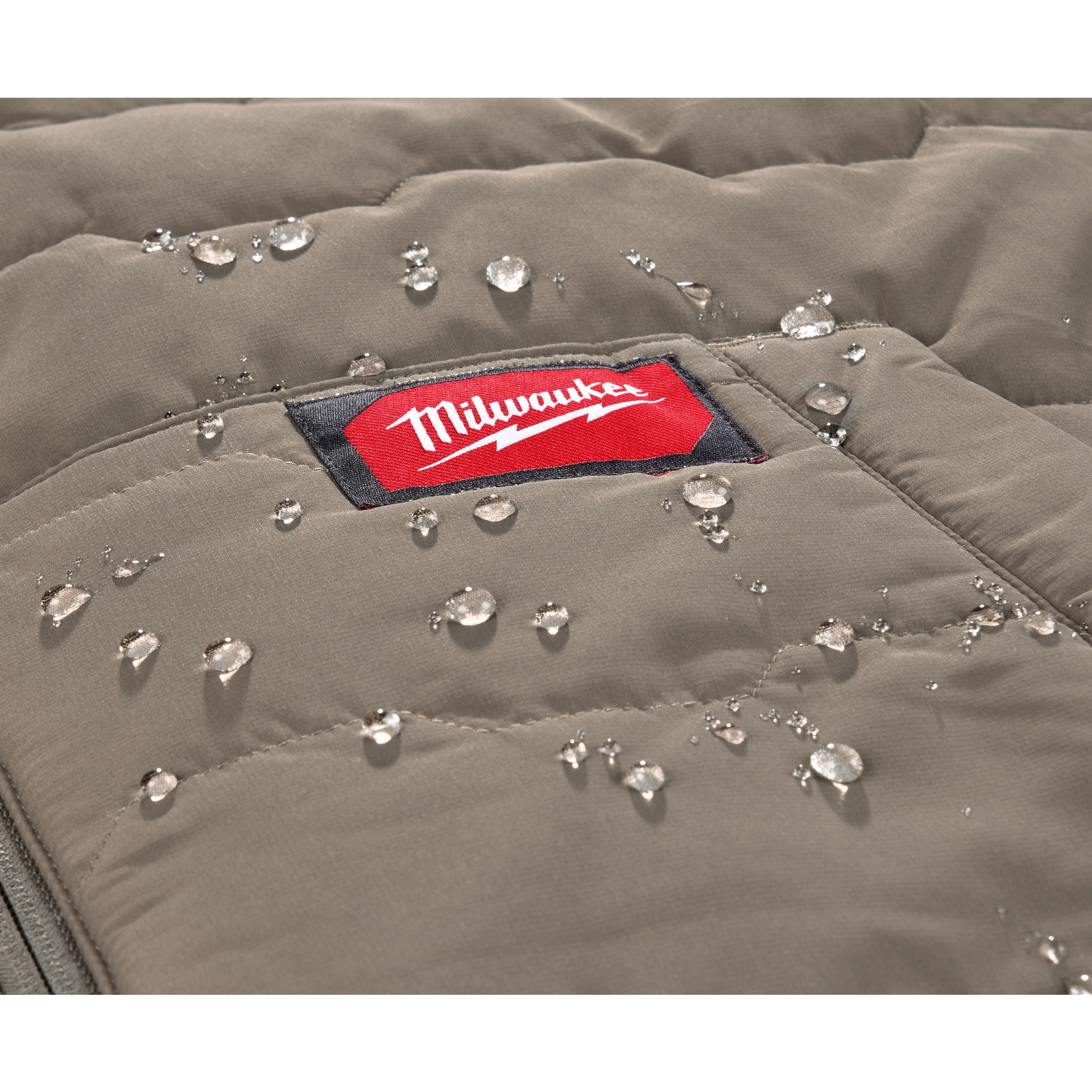 The image shows a close-up of the FREEFLEX™ Lightweight Insulated Vest with water droplets beading on its surface. The vest has a visible red and white Milwaukee logo. The fabric appears water-resistant.