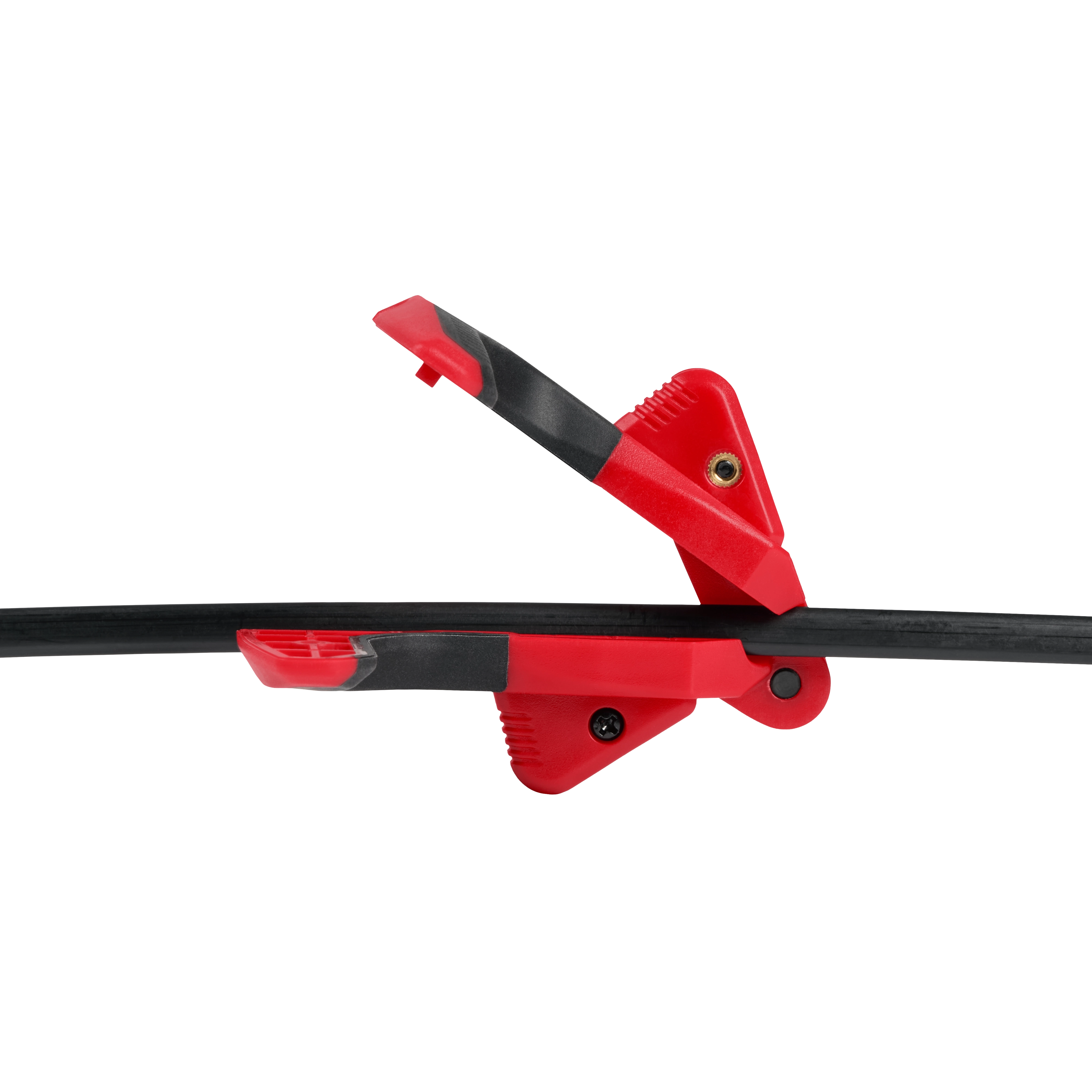 Red spring clamp holding black cables, isolated on a white background.