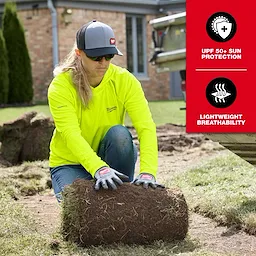Woman wearing a Women's WORKSKIN Hooded Sun Shirt kneels while handling sod in a yard, highlighting its UPF 50+ sun protection and lightweight breathability.