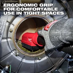 The AIR-TIP Boiler Coil Cleaning Brush Tool with an ergonomic grip is held by a gloved hand inside a boiler.