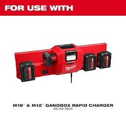The Milwaukee M18™ and M12™ Gangbox Rapid Charger is red with slots for charging four batteries simultaneously. A digital display is present for monitoring charge levels. It is designed for quick charging and is suitable for use with Milwaukee power tool batteries.