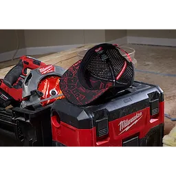 Flat Brim Snapback hat resting on a red and black toolbox with a power saw and a power drill partially visible in the background.