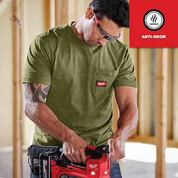 GRIDIRON Pocket T-Shirt - Short Sleeve Anti-odor in olive green, worn by a person operating a red power tool in a construction setting.